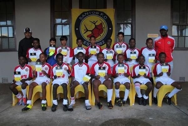 Santos FC Academy squad in red and white kit at the clubhouse