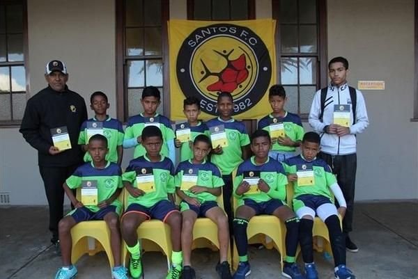 Santos FC Academy squad in green and navy kit at the clubhouse