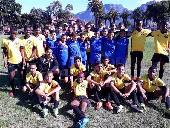 Santos FC players with an opposing team at a club football festival, Table Mountain in the background